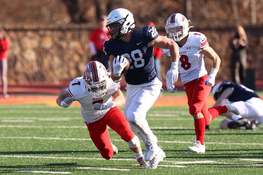 With the ball in hand, senior wide receiver Reice Kennedy runs past the defensive players. 