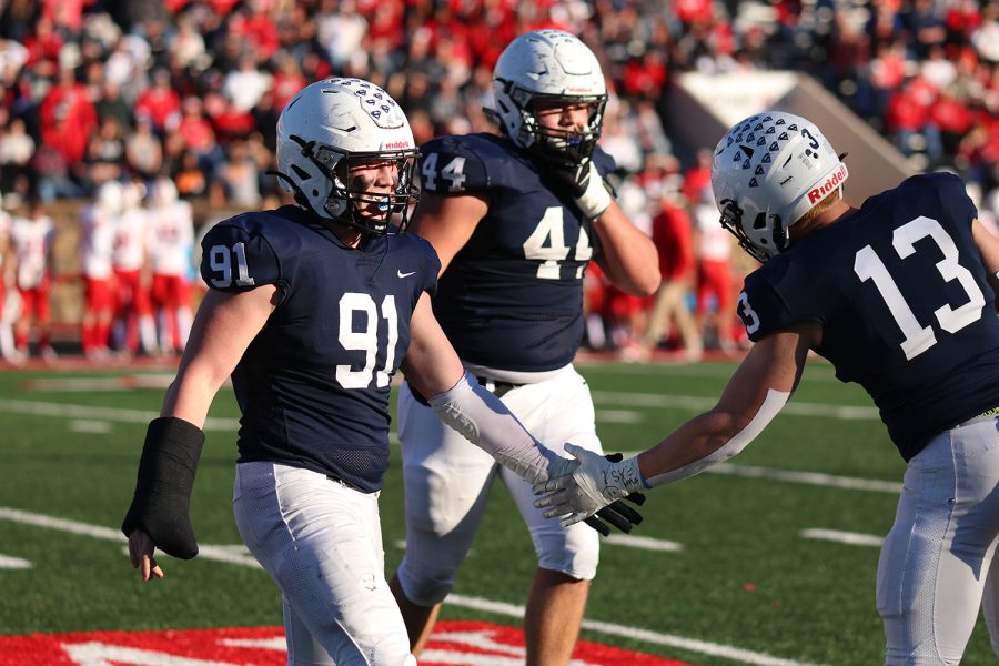 High-fiving his teammate, senior defensive lineman Cody Moore celebrates after Mill Valley gets the ball back. 