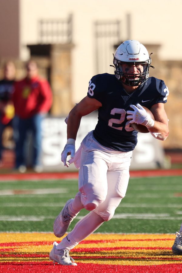 After getting passed the ball, senior wide receiver Reice Kennedy runs the ball. 