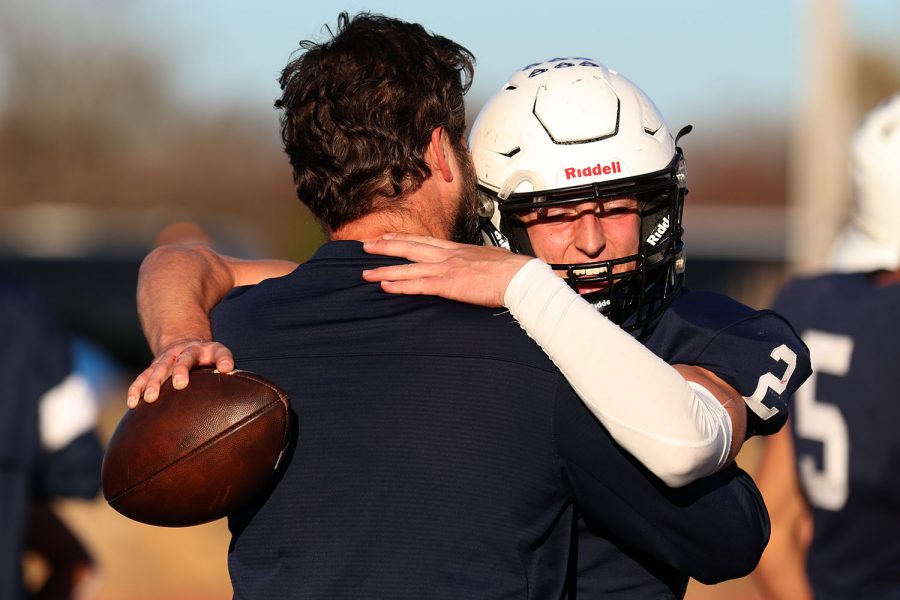 After winning the game, senior quarterback Hayden Jay embraces the coach.
