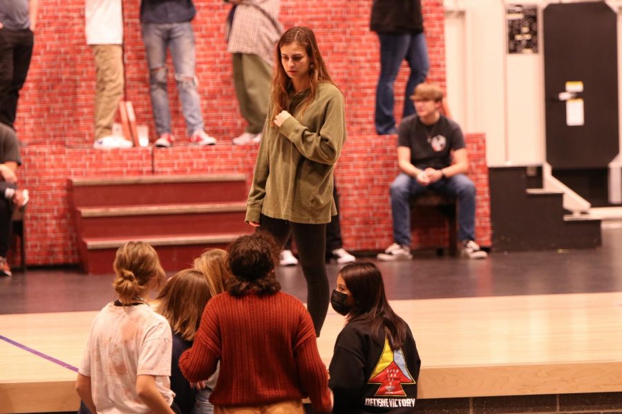 Prepping for the musical, senior Lauren Payne talks to a group of student directors and cast members to discuss rolls Monday, Oct. 24. 
