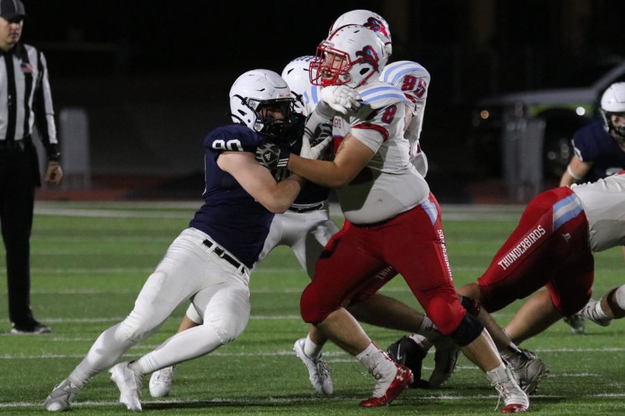 Senior defensive lineman Grant Yockey pushes through the opposing player in hopes of tackling the quarterback. 
