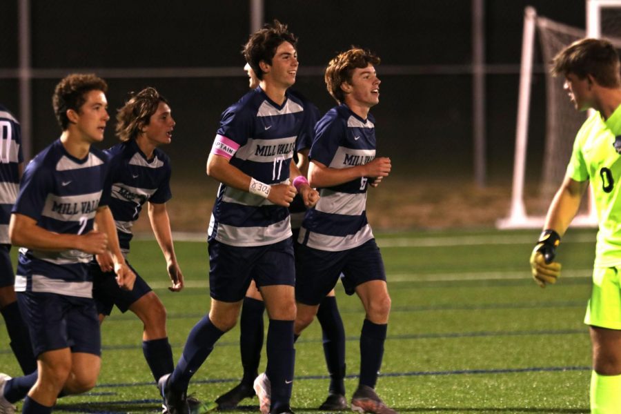 Wearing his pink captain’s band on the soccer field, senior Ryan Wingerd leads his team to midfield to assume his position as right wing on Oct. 28.