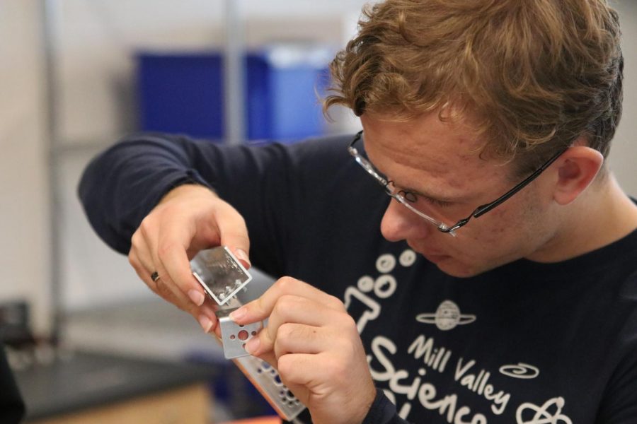 Testing different pieces, senior Jordan Manning works to complete his assignment of putting together a robot Friday, Oct. 22.