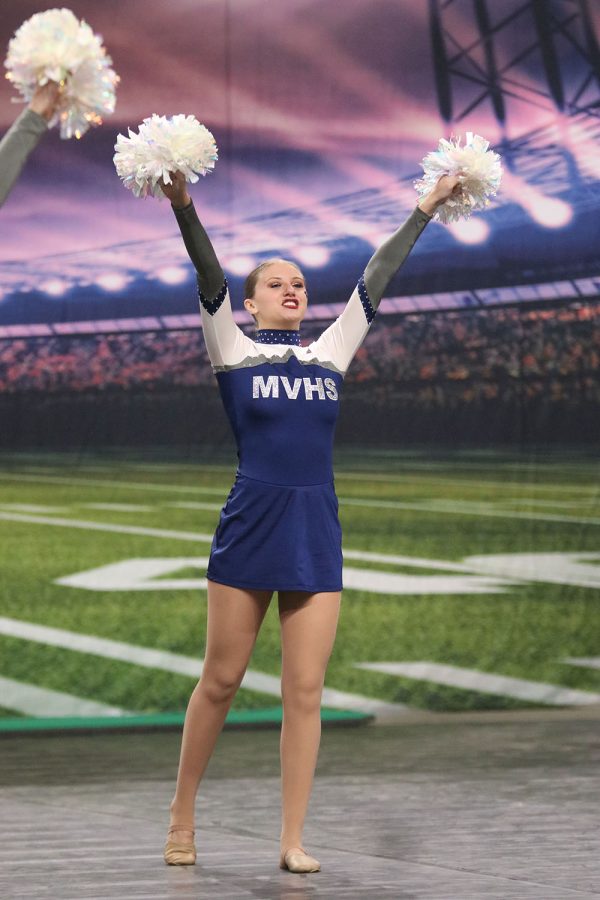 With both hands in the air, senior Ella Lorfing yells towards the crowd. 