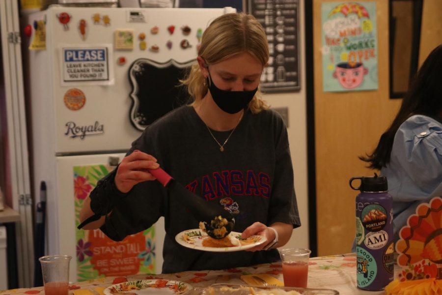 Scooping sweet potato casserole on her plate, sophomore Ella Bowling enjoys Sidesgiving.