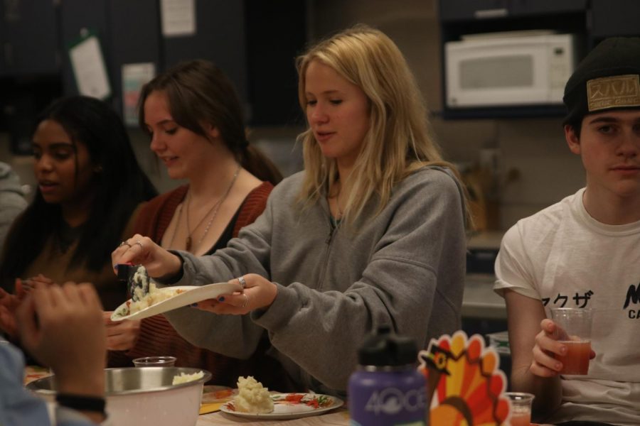 Holding her plate, senior Katen McLeod gets a helping of mashed potatoes.