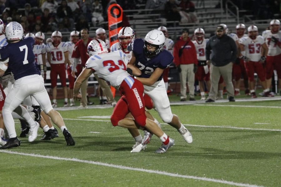 Preventing the opponent from getting to the ball, sophomore Sully Suderman holds the line.