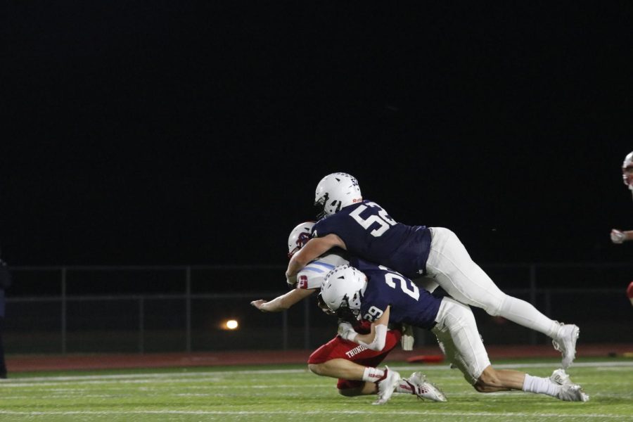 After breaking through the offense, juniors Grant Rutkowski and Dylan Massey sack the quarterback. 