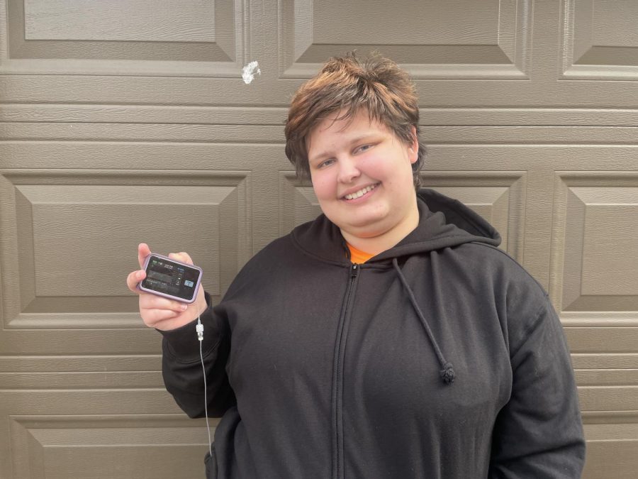 Senior Elisabeth Peters shows her small device called t-slim that can help her to take control of her blood sugar on Nov. 13