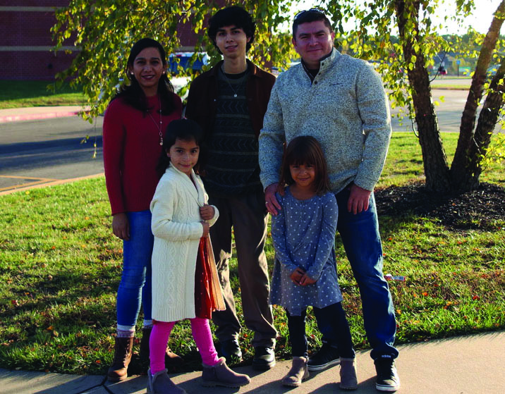 Junior Diego Medina-Castanon poses with his host family in front of Mill Valley on Friday, Oct. 29