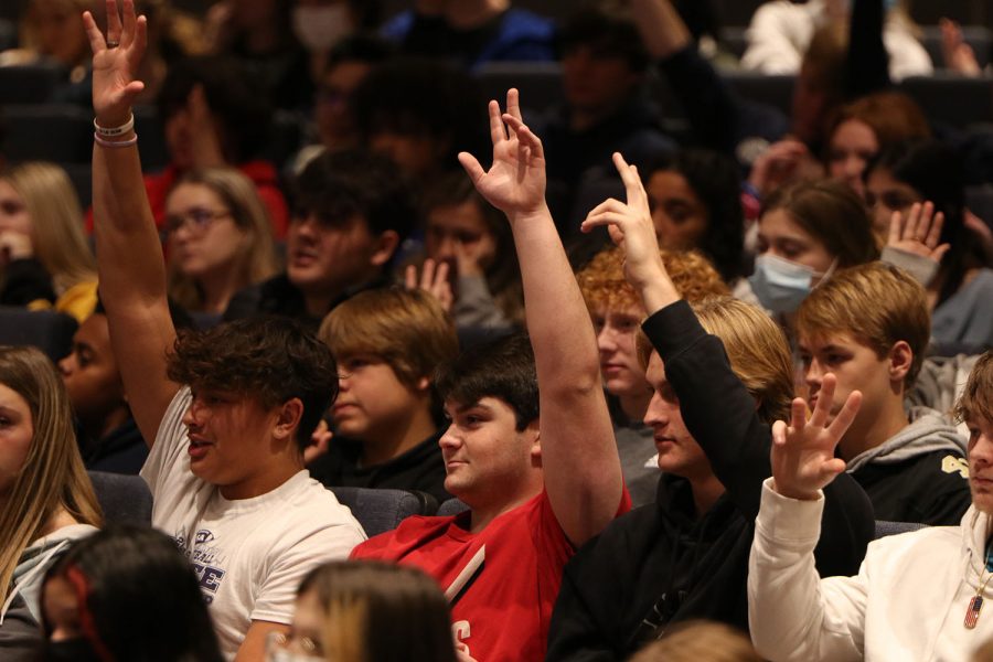 Hands in the air, juniors Parker Volski and Spencer Vaka vote on which drug they believe is the fake. 