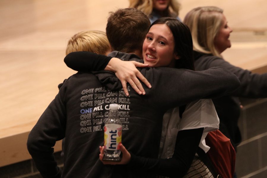 Embracing Randy Davis, junior Lauren Aycock speaks with the Davis family following the assembly.