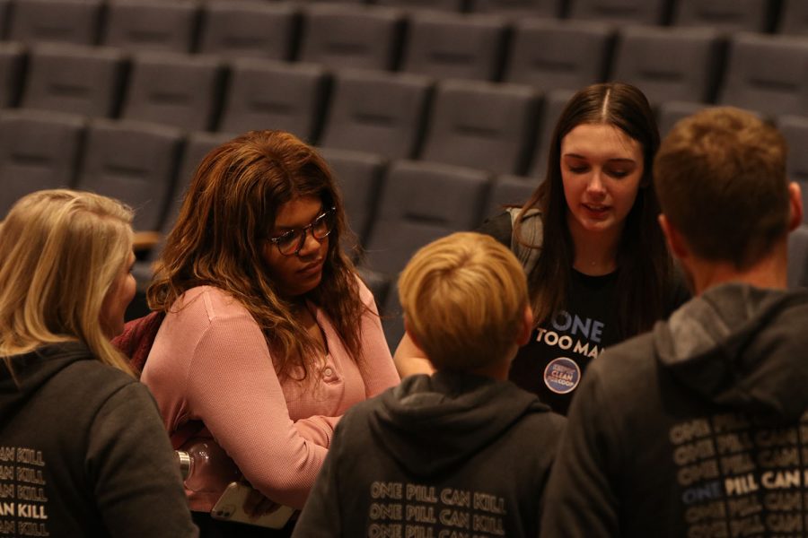 Following the assembly, junior Makayla Hilman and sophomore Ava Vannier meet with the Davis family. 