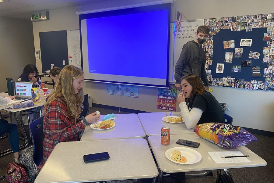 As they eat, seniors Summer Anderson and Grace Emerson converse before watching ‘Coco.’ 