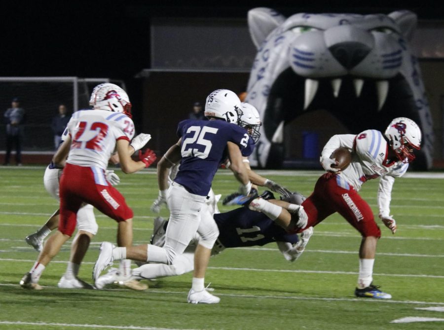 Reaching to the quarterback, senior Ben Fitterer attempts to complete the tackle.