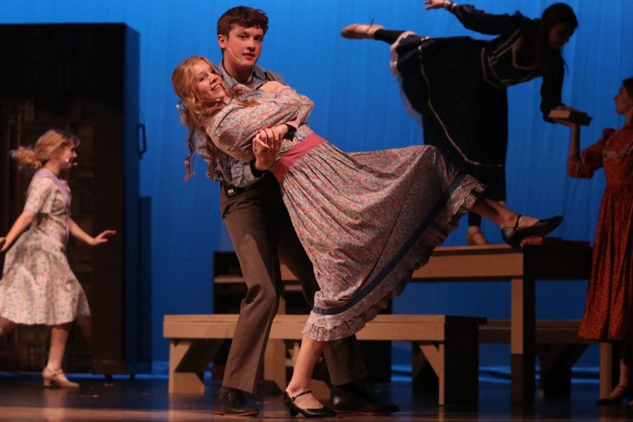 With her leg in the air, senior Isabel Aerni dances with senior Jack Bowden during the song “Marian the Librarian.”