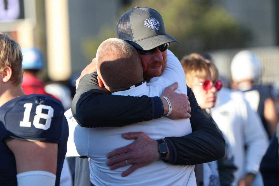 Coach Applebee and Coach Hudgins celebrate the teams third straight state title after the game. 