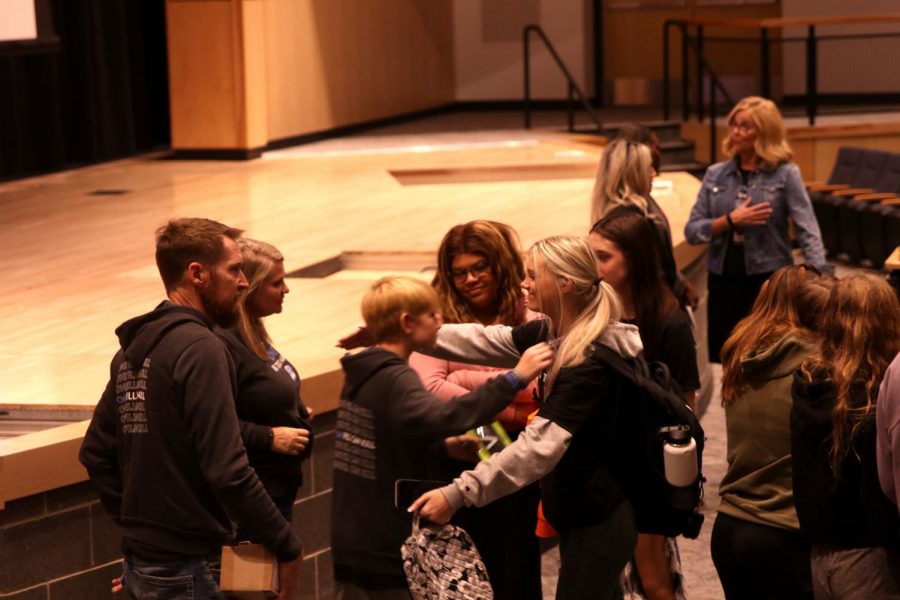 Going in for a hug, sophomore Carley Broyles embraces Grayson Davis.