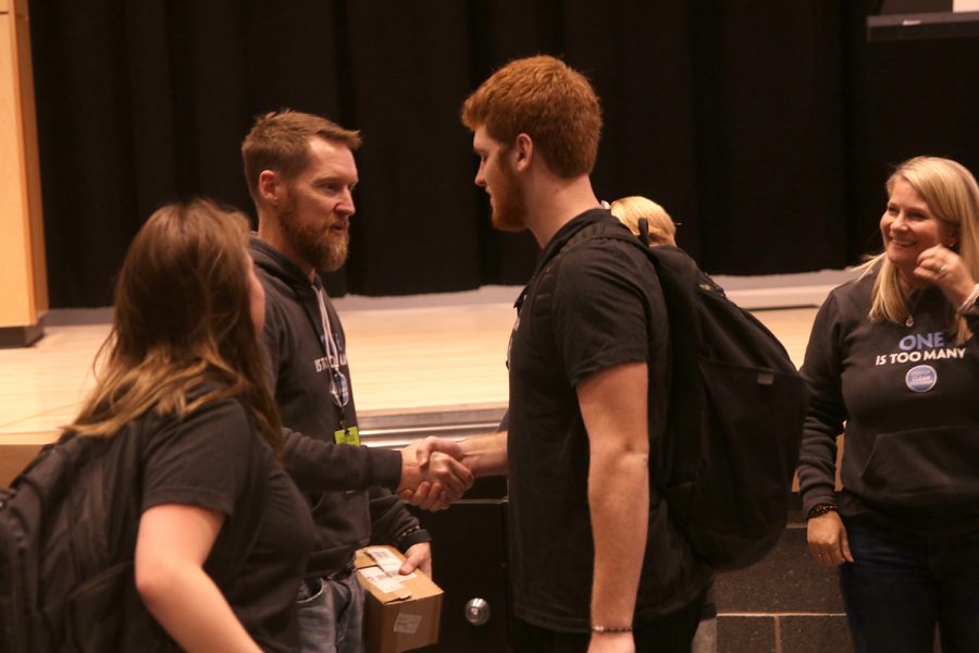 To give his support, sophomore Koby Cooke shakes hands with Randy Davis.