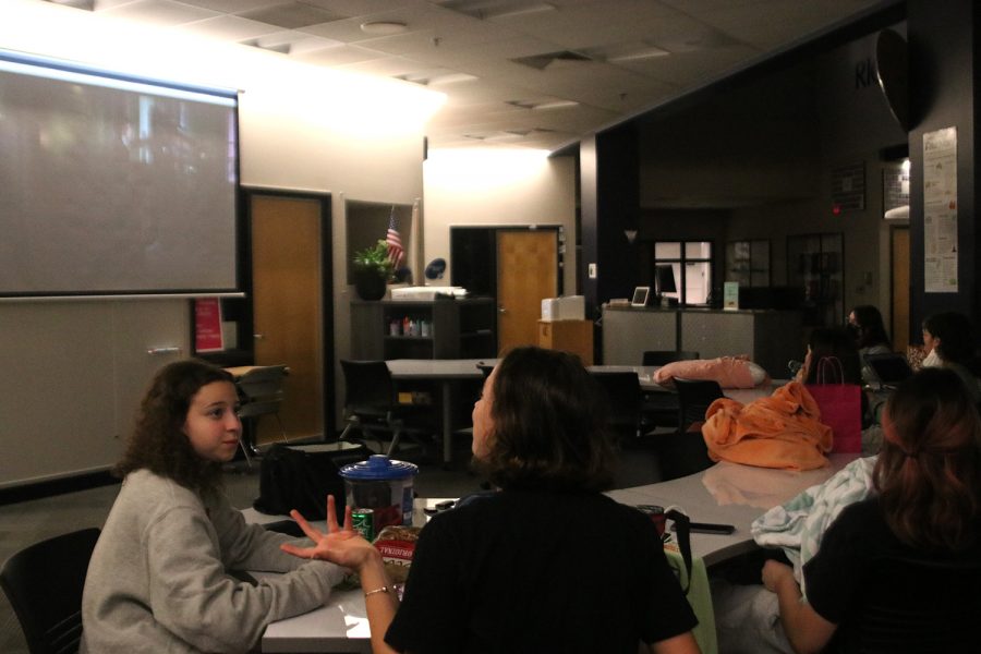 While watching Little Women for Women Empowerment Wednesday, Nov. 3, junior Alex Cobin and sophomore Bridgit Duffin talk before the start of the movie.