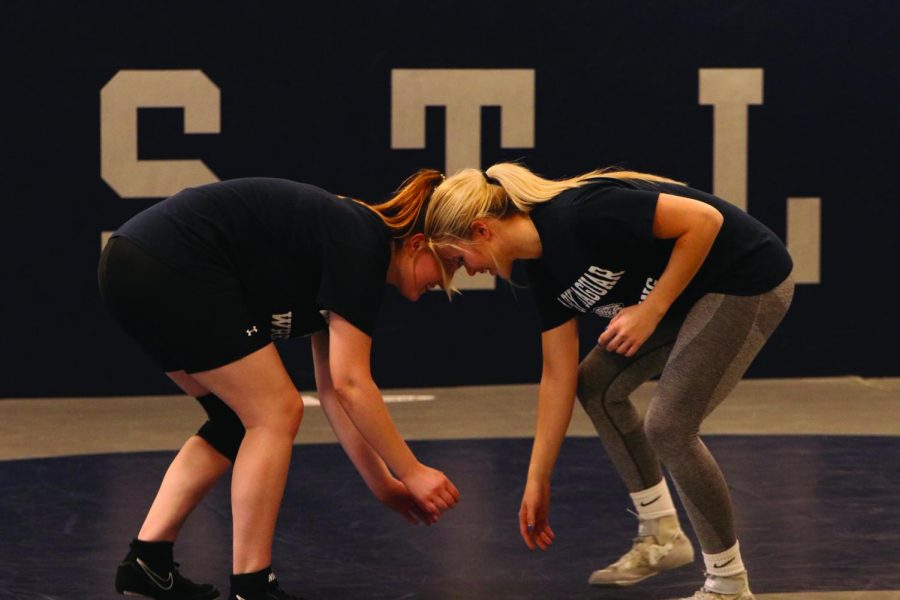 Seniors Shaye Neilson and Katen McLeod are in the wrestling stands getting ready to match.