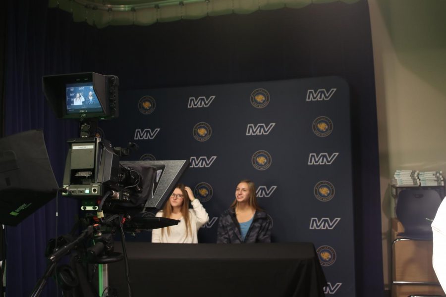 Rehearsing for their live broadcast of announcements before seminar, sophomores Lucy Roy and Chaley Spaulding read their script Friday, Nov. 19. Photo by Amy Hill