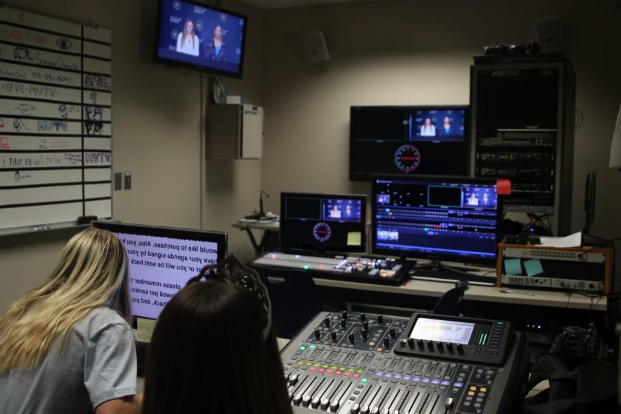 Junior Jenna Myers and sophomore Olivia Huston help set up the script and audio for announcements before their live broadcast of announcements for seminar on  Friday Nov. 19 Photo by Amy Hill
