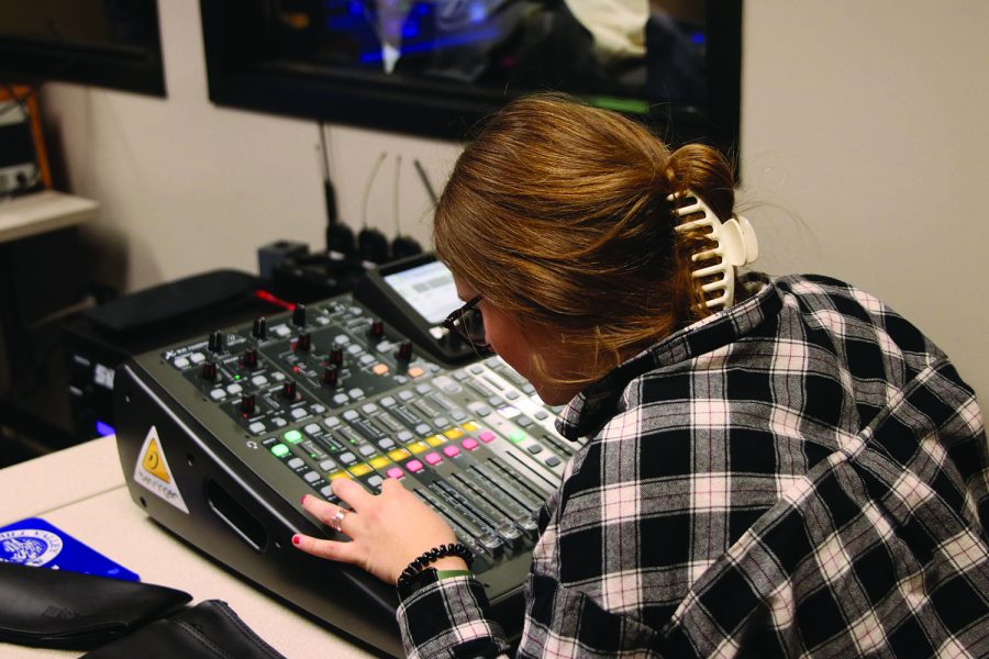 In the sound booth, sophomore Lucy Roy adjusts audio settings for the airing of MVTV Thursday, Dec 3