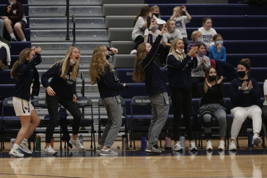 Cheering from the sideline, freshman Marissa Hoelting, junior Ryleigh Kennedy, sophomore Megan Kephart and seniors Greta Trowbridge and Maggie Smith celebrate as the team scores another point. 