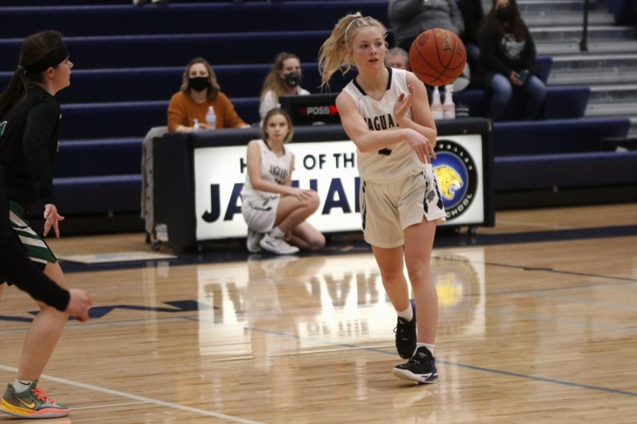 Looking to her teammate, sophomore Keira Franken passes the ball. 