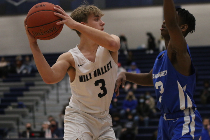 Looking for an open teammate, senior Jackson Van Dyke attempts to pass the ball.