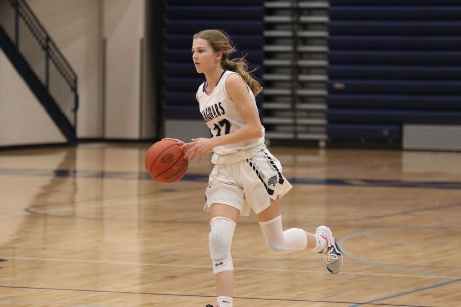 Ball in hand, freshman Averie Landon dribbles the ball down the court. 