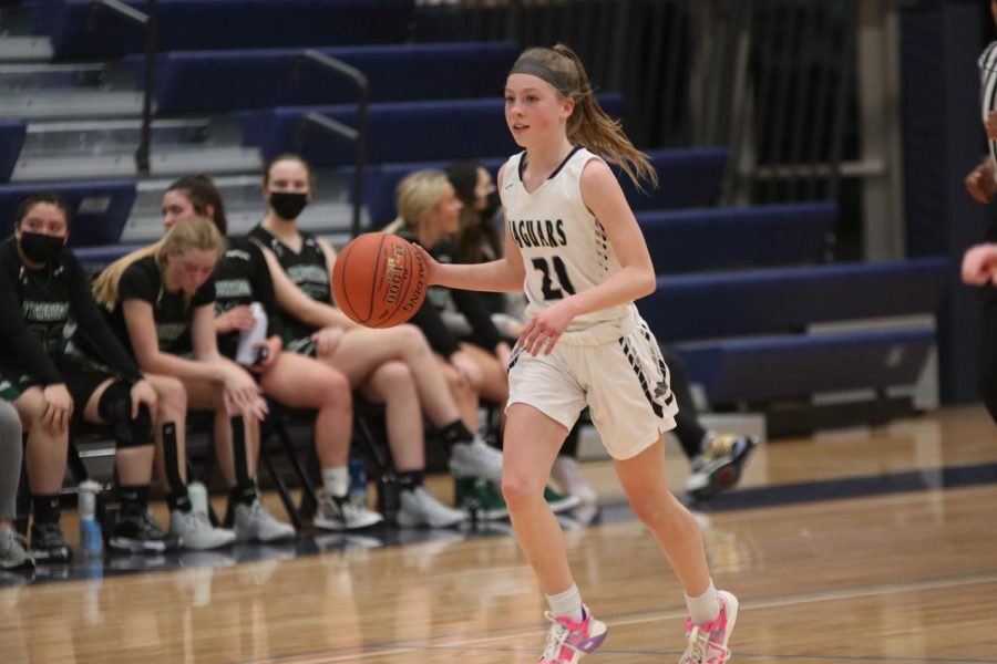 Eyes on the court, freshman Josie Benson looks out to her teammates to pass the ball.