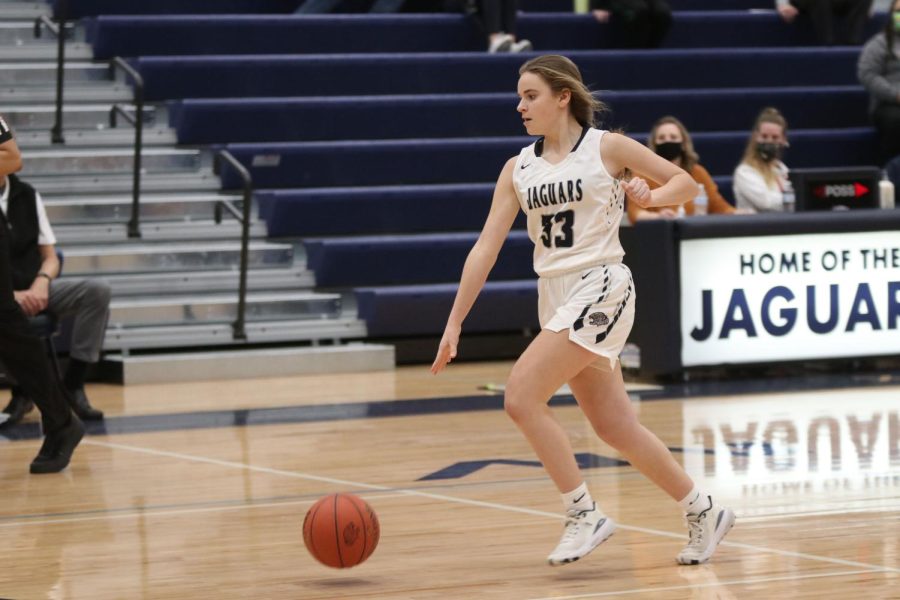 After stealing the ball from her opponent, freshman Marissa Hoelting dribbles down the court. 