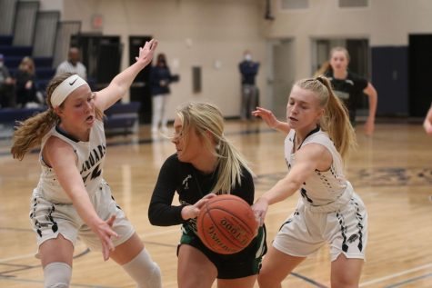 Arms stretched out, senior Emree Zars and junior Sophie Pringle guard a Free State player. The girls defeated Lawrence Free State at home Tuesday, Jan. 18 with a final score of 56-16. 