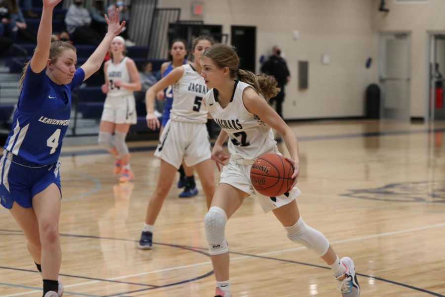 Ball in hand, freshman Averie Landon dribbles past her opponent.