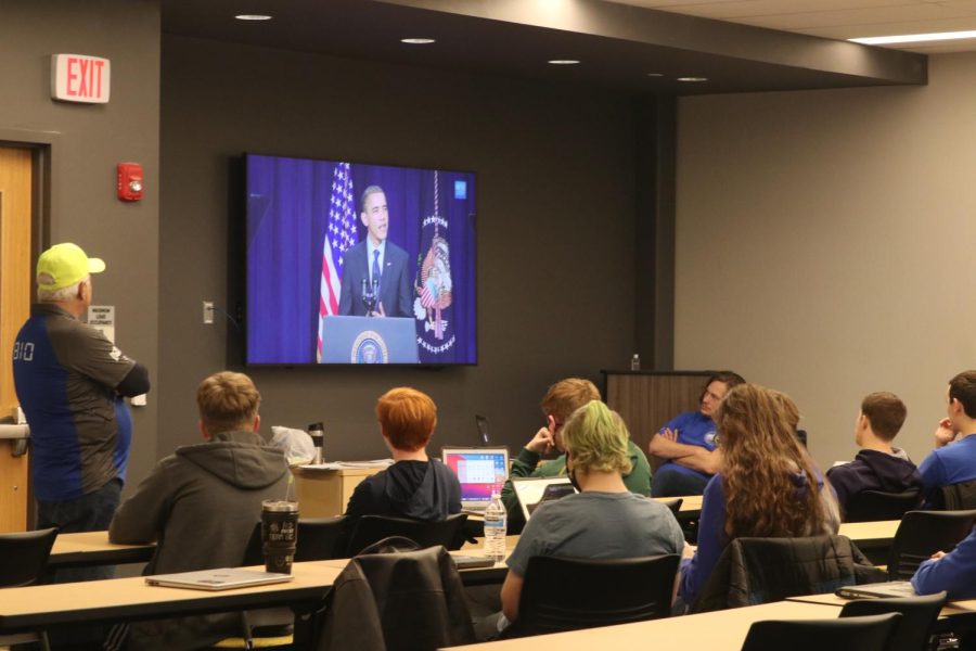 As they wait for the First Robotics Competition live streamed kickoff to start, lead mentor Gary Hannah boosts the team’s excitement by showing videos of past robotics events and competitions Saturday, Jan. 8