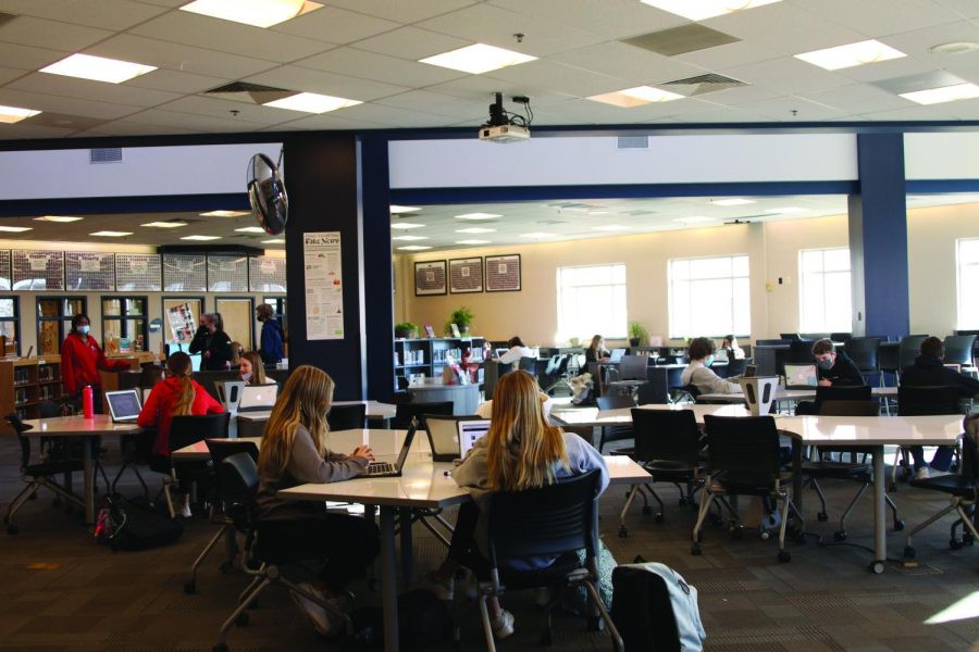 Sitting at the new tables, sophomores in English teacher Sara Sedgwick’s Honors English 10 class work on their research for a project Thursday, Jan. 20. The new tables and shelves were purchased using leftover money from the school renovations last summer.