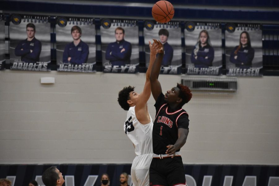 Participating in the jump ball at the beginning of the game, senior Adrian Dimond allowed Mill Valley to gain possession of the ball Friday, Jan. 8
