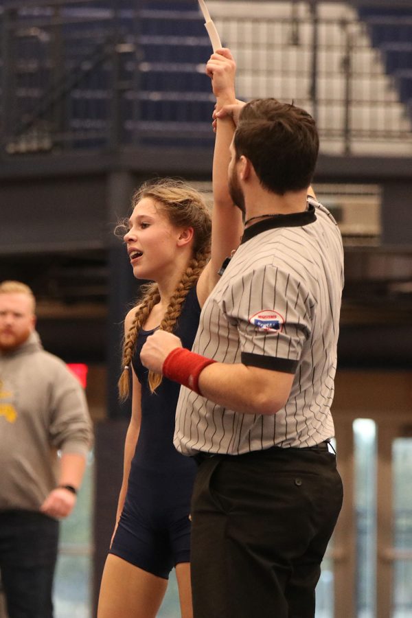 After pinning her Shawnee Mission South opponent, freshman Raina Frantz’s hand is raised in the air, announcing her the winner.