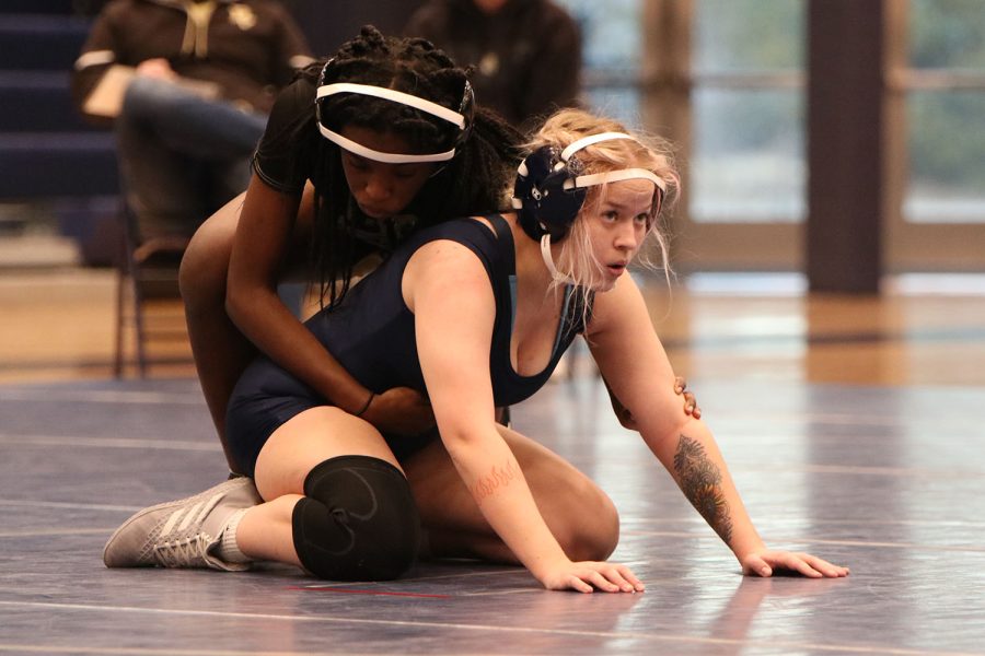 In the starting position under her opponent, senior Rylee Allen-Atchison looks at the referee as the round begins.