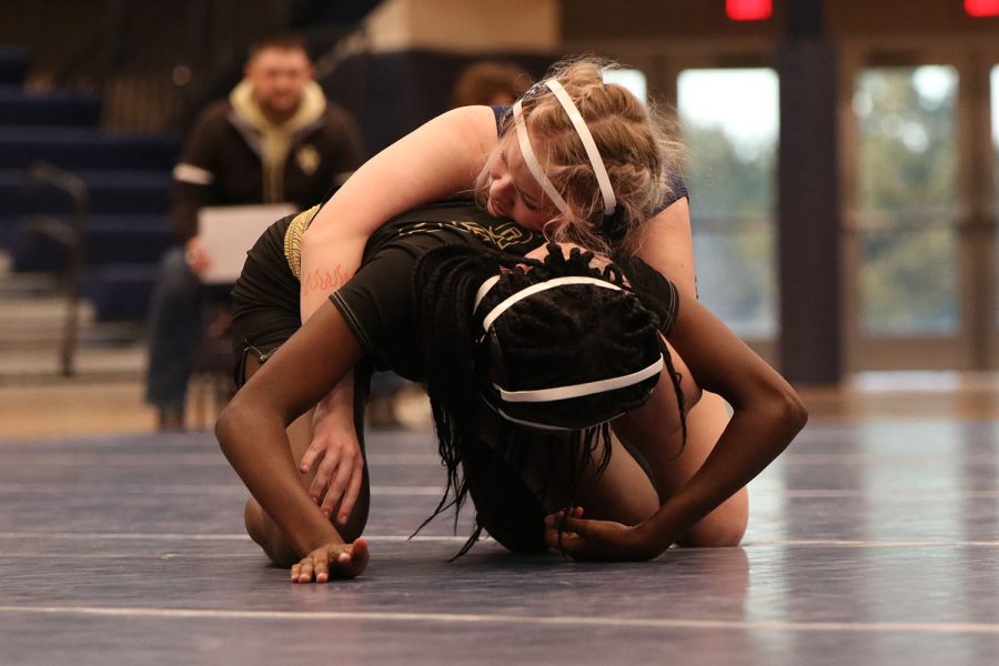 As her opponent tries to escape her grasp, senior Rylee Allen-Atchison attempts to keep her on the ground.