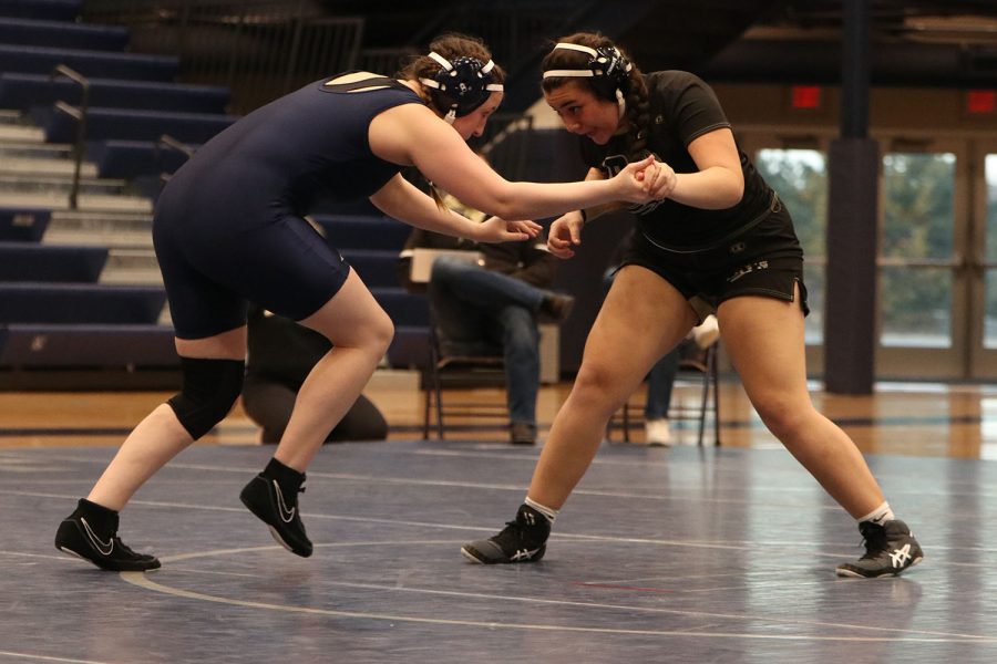 As the match begins, senior Shaye Nielsen races forward to her opponent, grasping her hands.