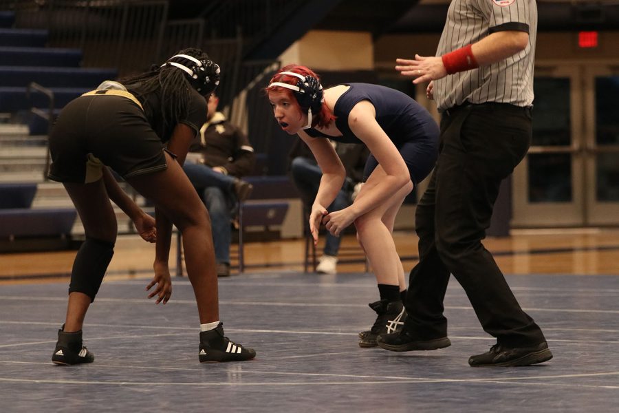 After the referee blows the whistle, freshman Cadence Kerr circles around the mat with her opponent.