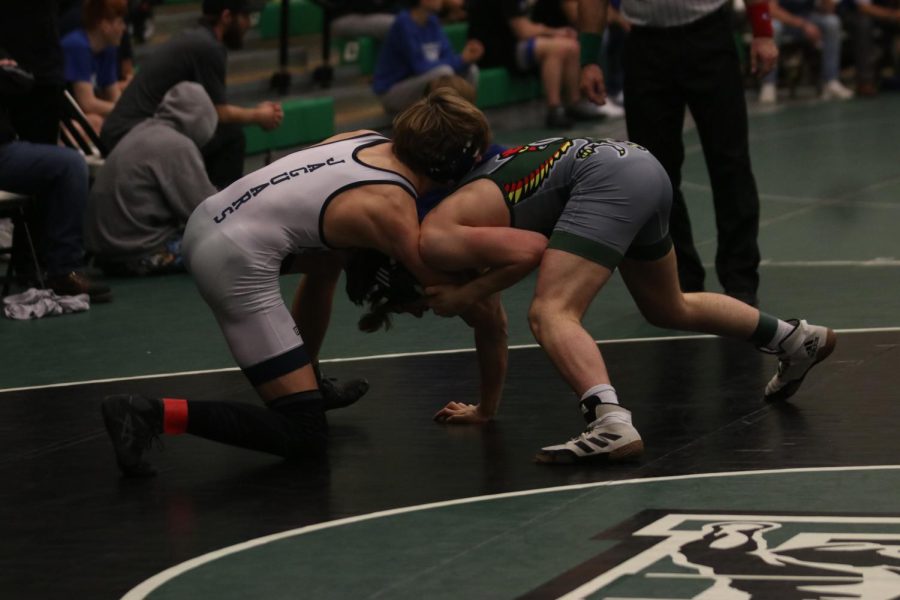 Senior Jacob McGlasson works hard to defeat his opponent by holding them in a headlock.