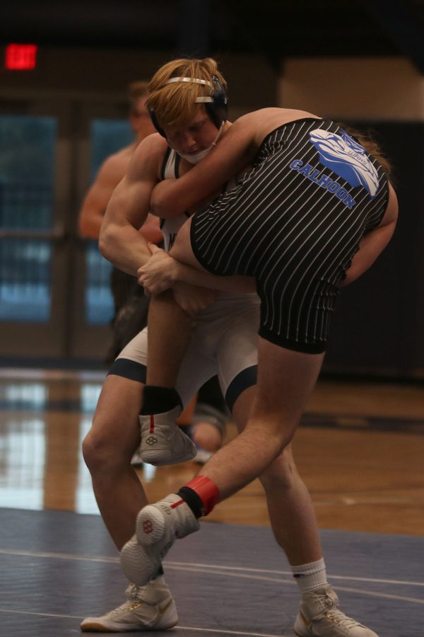 Picking up his opponent, junior Holden Zigmant begins to adjust his grip in order to take his competitor down swiftly. 