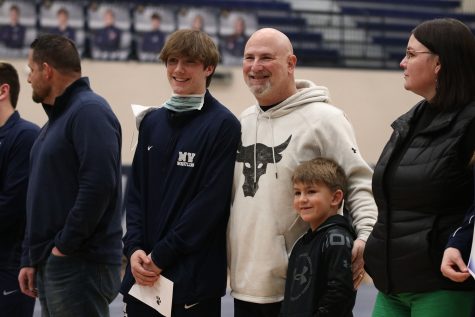 Posing for a picture, senior Salvatore Vita stands beside his dad and little brother while celebrating his senior season. 