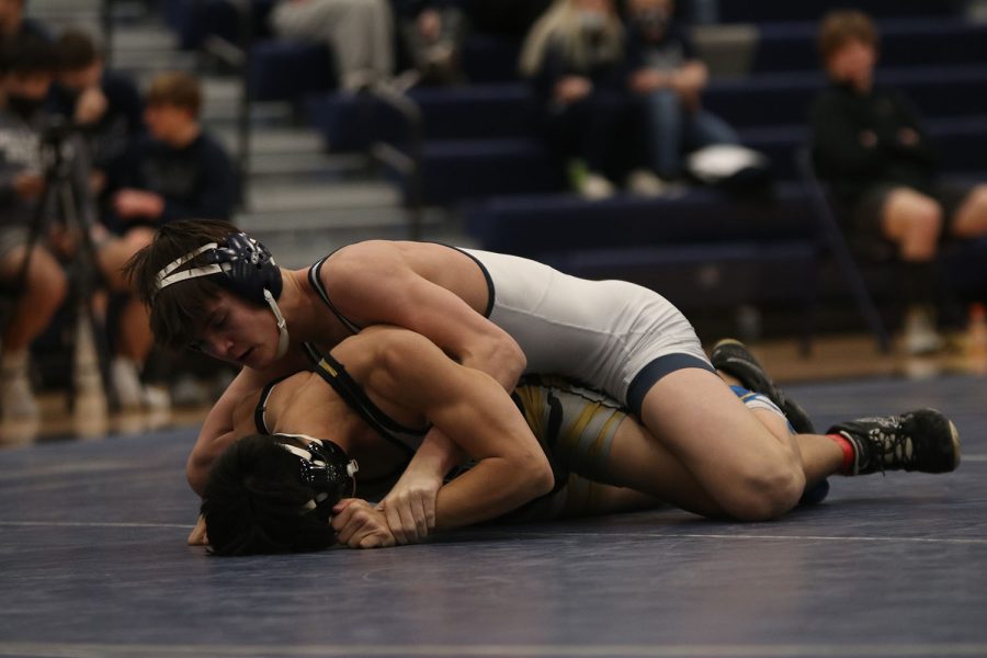 Pinning the opposing team’s player to the ground, sophomore Dillon Cooper begins to unwrap the opponent’s hands from under him. 