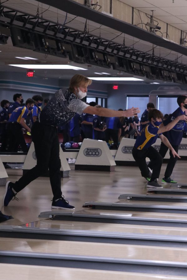 After releasing the ball, junior Preston Oliver watches as it rolls down the lane.
